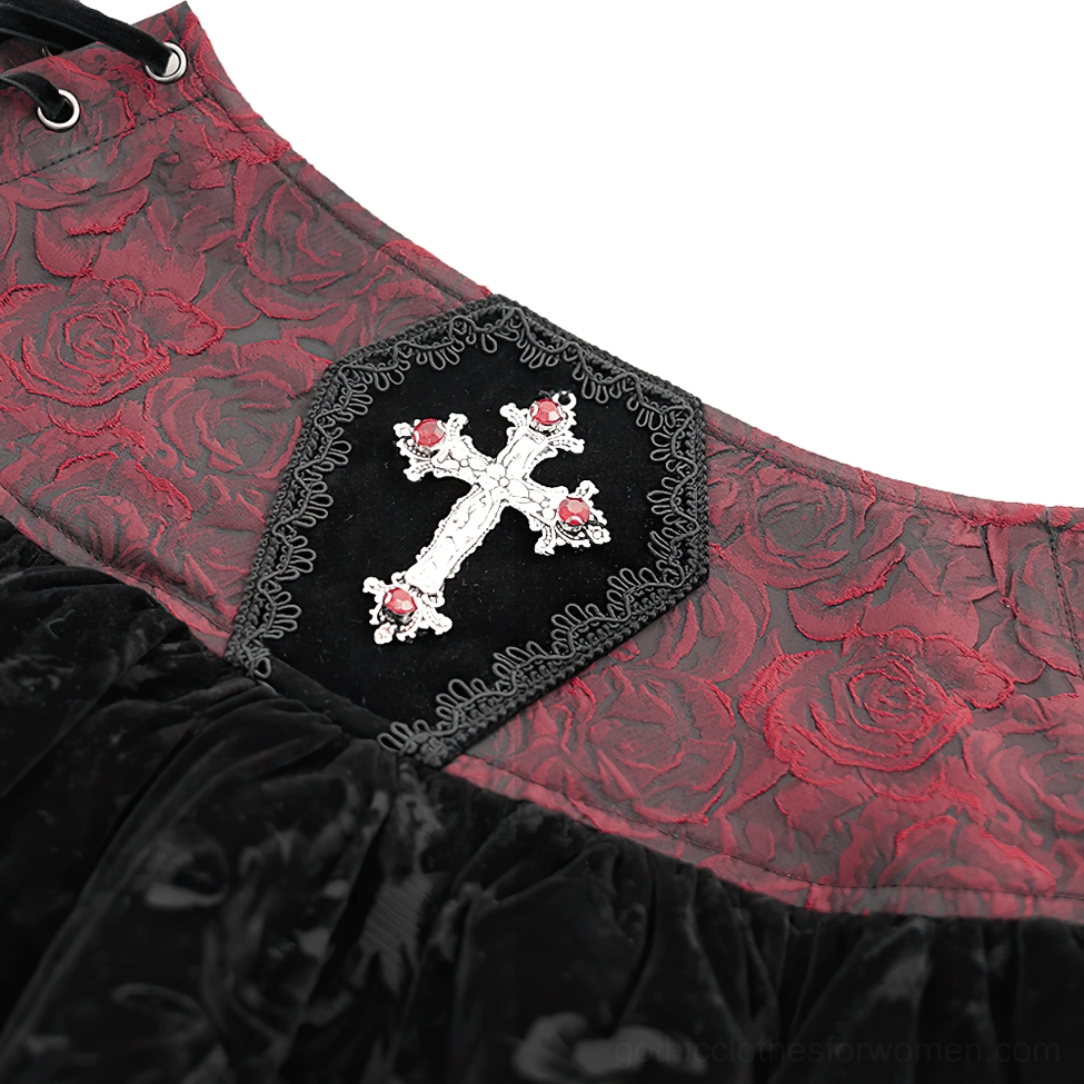 Close-up detail of gothic skirt waist ornament showing silver cross decor red rose jacquard fabric and coffin trim