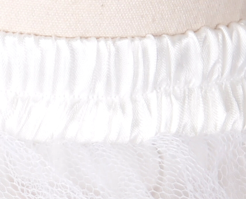 White elastic waistband detail of gothic mesh skirt showing stitched polyester construction