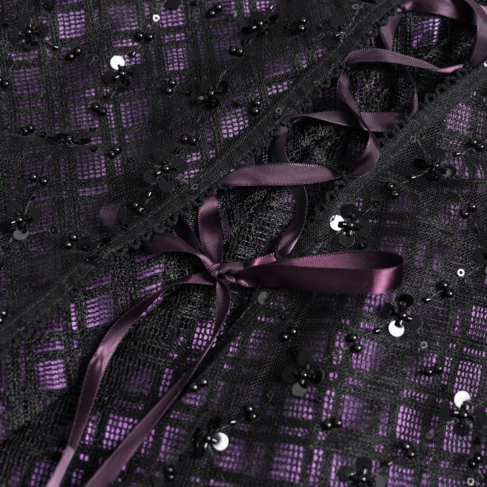 Detailed close-up of gothic purple tulle skirt fabric showing purple plaid base layer, black sequined mesh overlay, and decorative ribbon bow accents