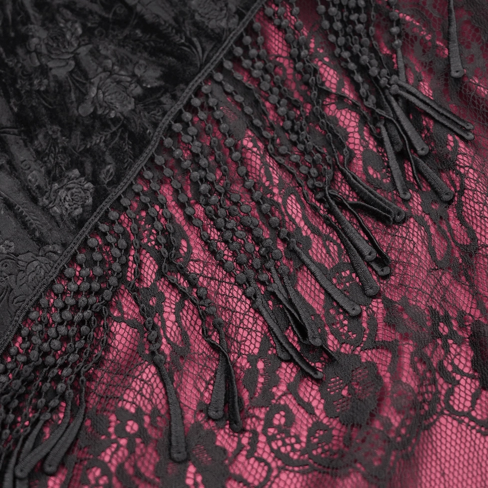 Detailed close-up of gothic skirt fabric composition featuring black tassel trim, ornate black floral lace overlay, and wine red underlayer