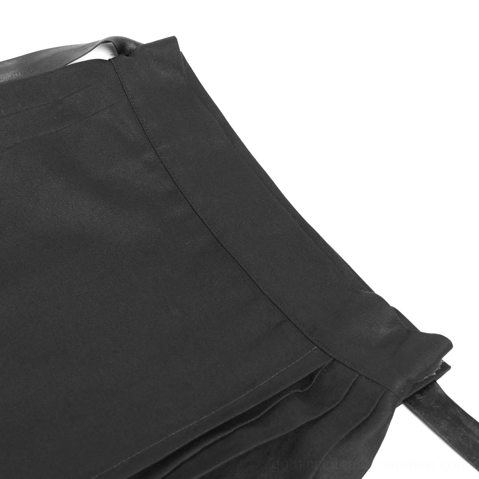 Close-up detail of black gothic skirt fabric, pleated textile with faux leather waistband trim