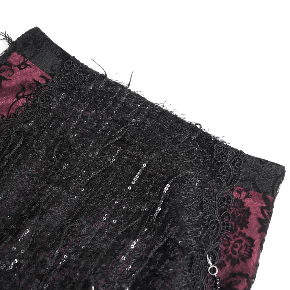 Flat lay close-up of gothic skirt fabric showing sequined black lace texture and burgundy damask lining pattern