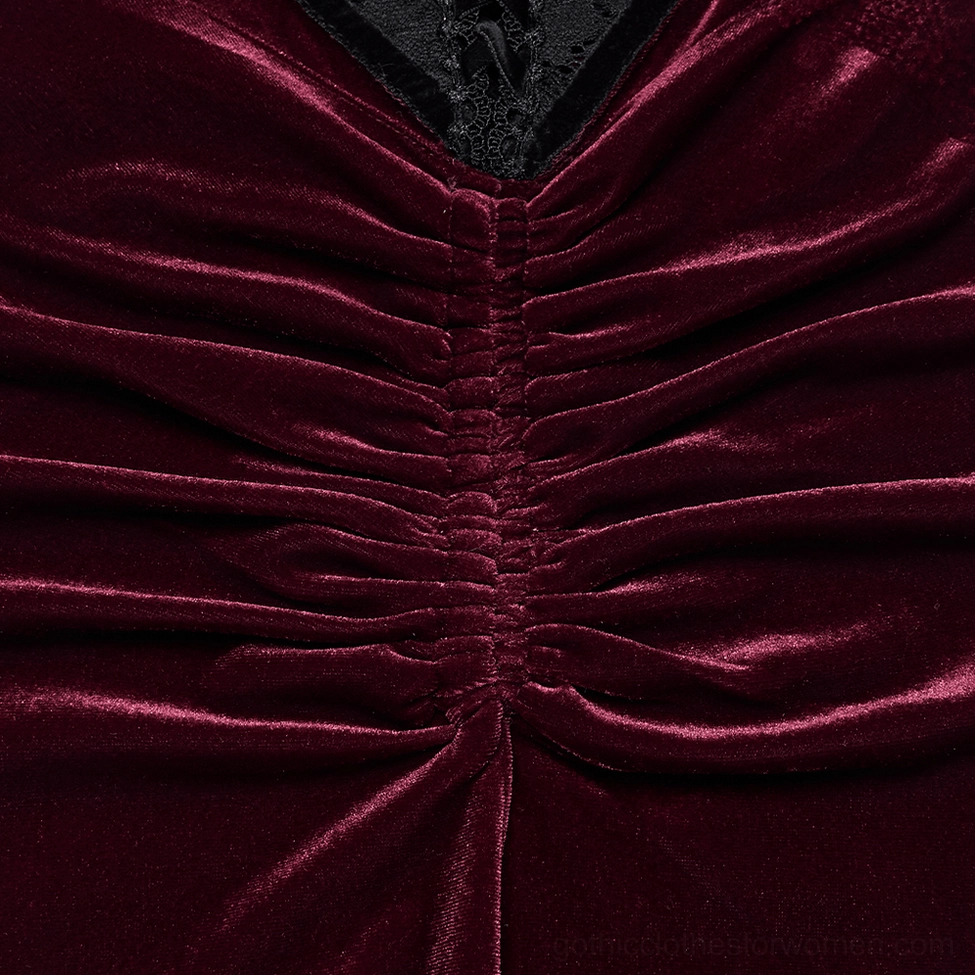 Macro close-up of burgundy velvet gothic skirt front showing concentrated ruched texture detail and central seam construction