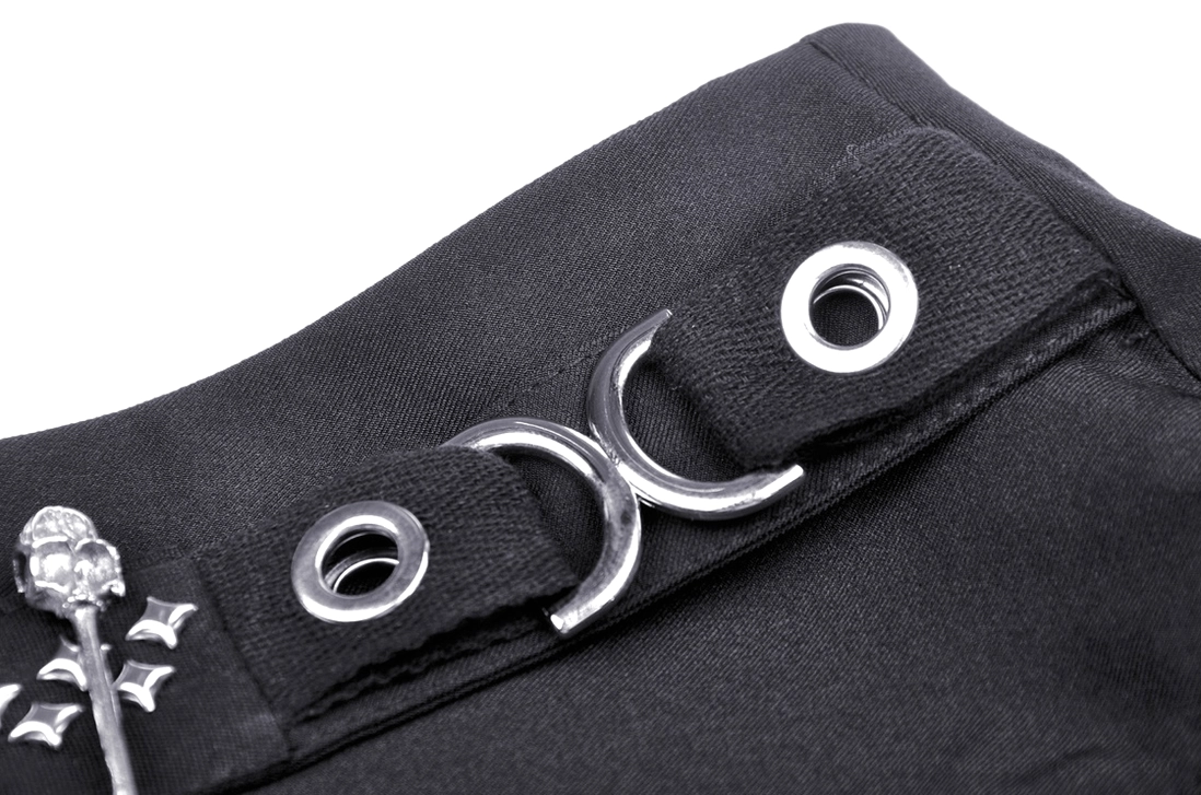Close-up detail of gothic skirt waist hardware: metal grommets, crescent buckles, and skull-themed studs