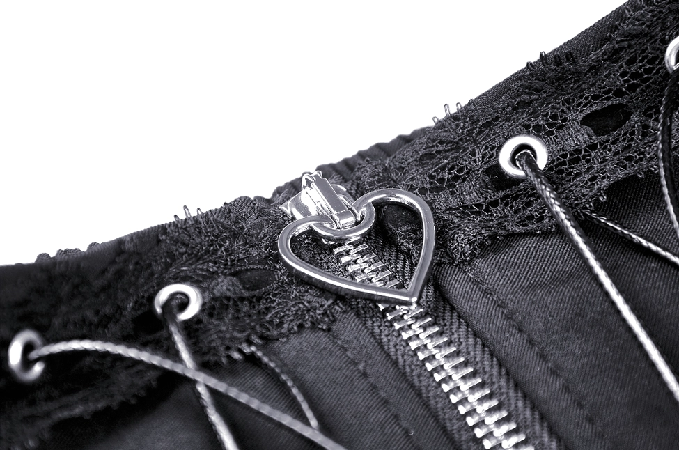 Close-up detail of black gothic skirt heart-shaped metal zipper pull and adjustable waist hardware