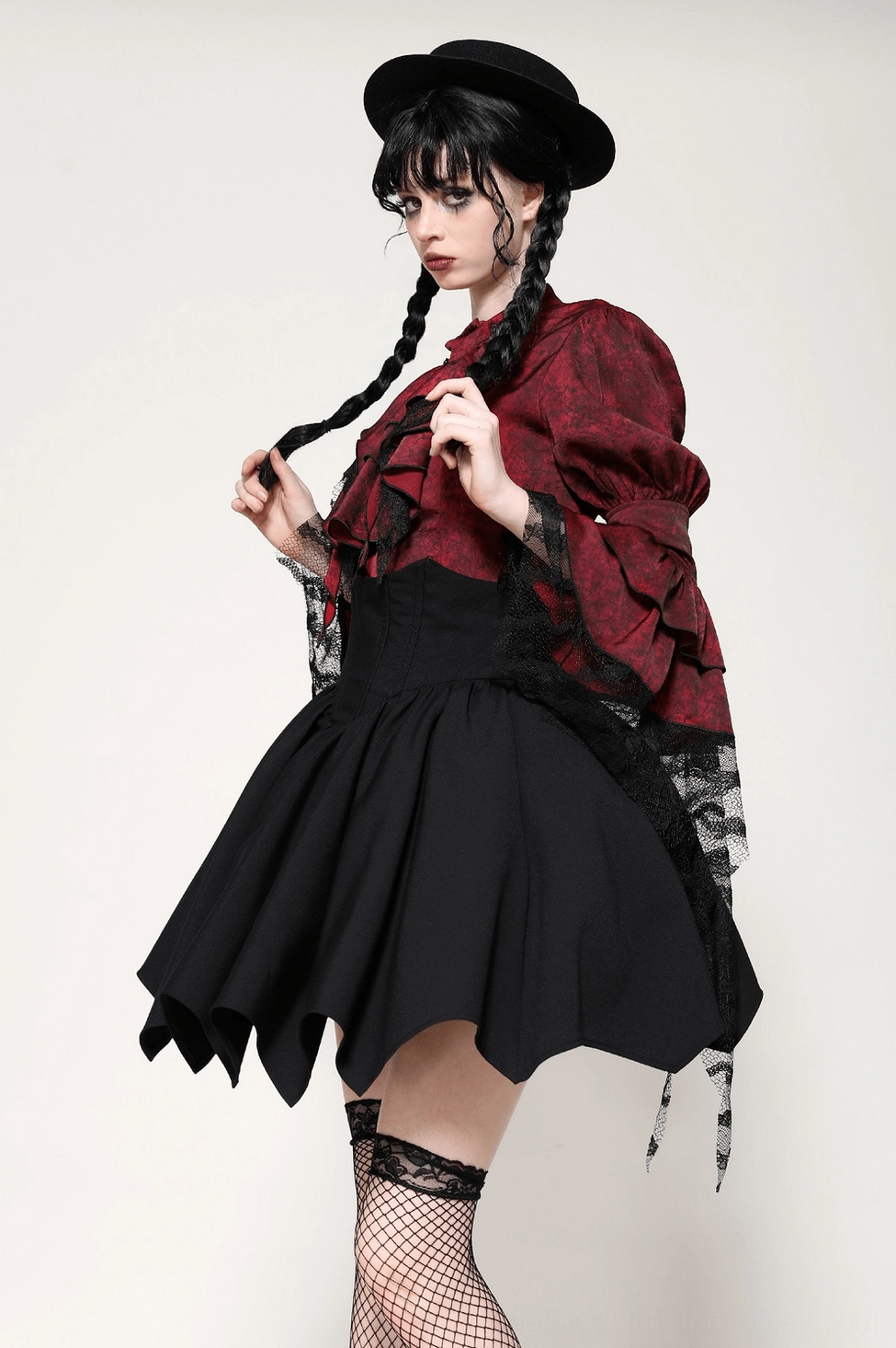 Gothic black skirt hemline detail showing bat wing cutting pattern asymmetry