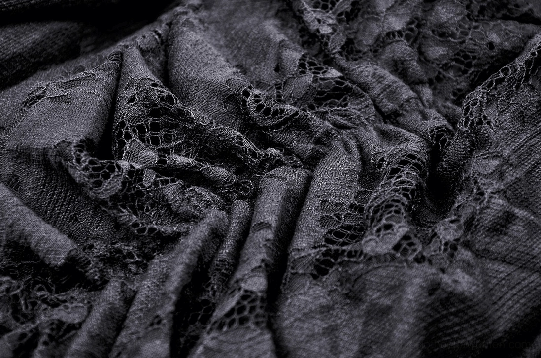 Intricate mesh lace pattern detail of black gothic high-low skirt with wrinkled texture