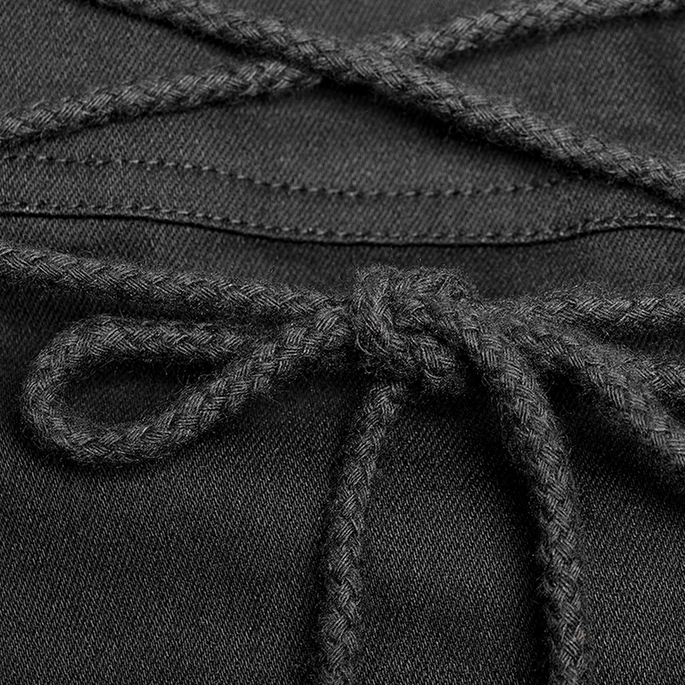 Macro photography of lace-up cord detail on Gothic half kilt showing braided black cord, tied bow knot, and reinforced fabric stitching