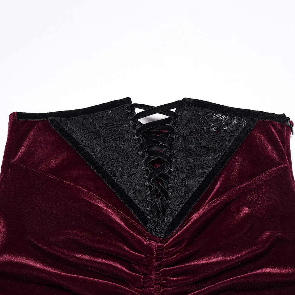 Close-up macro view of burgundy velvet gothic skirt waist showing lace-up corset panel detail with black lace insert
