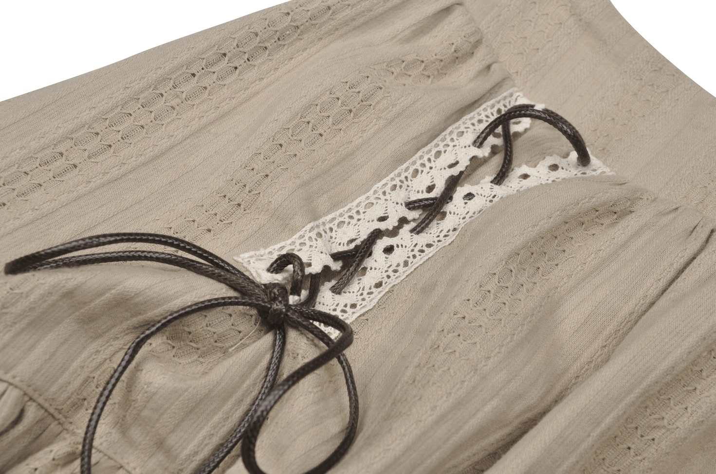 Close-up detail of gothic beige skirt lace-up ties showing leather bow ties, eyelet fabric texture, and precision craftsmanship