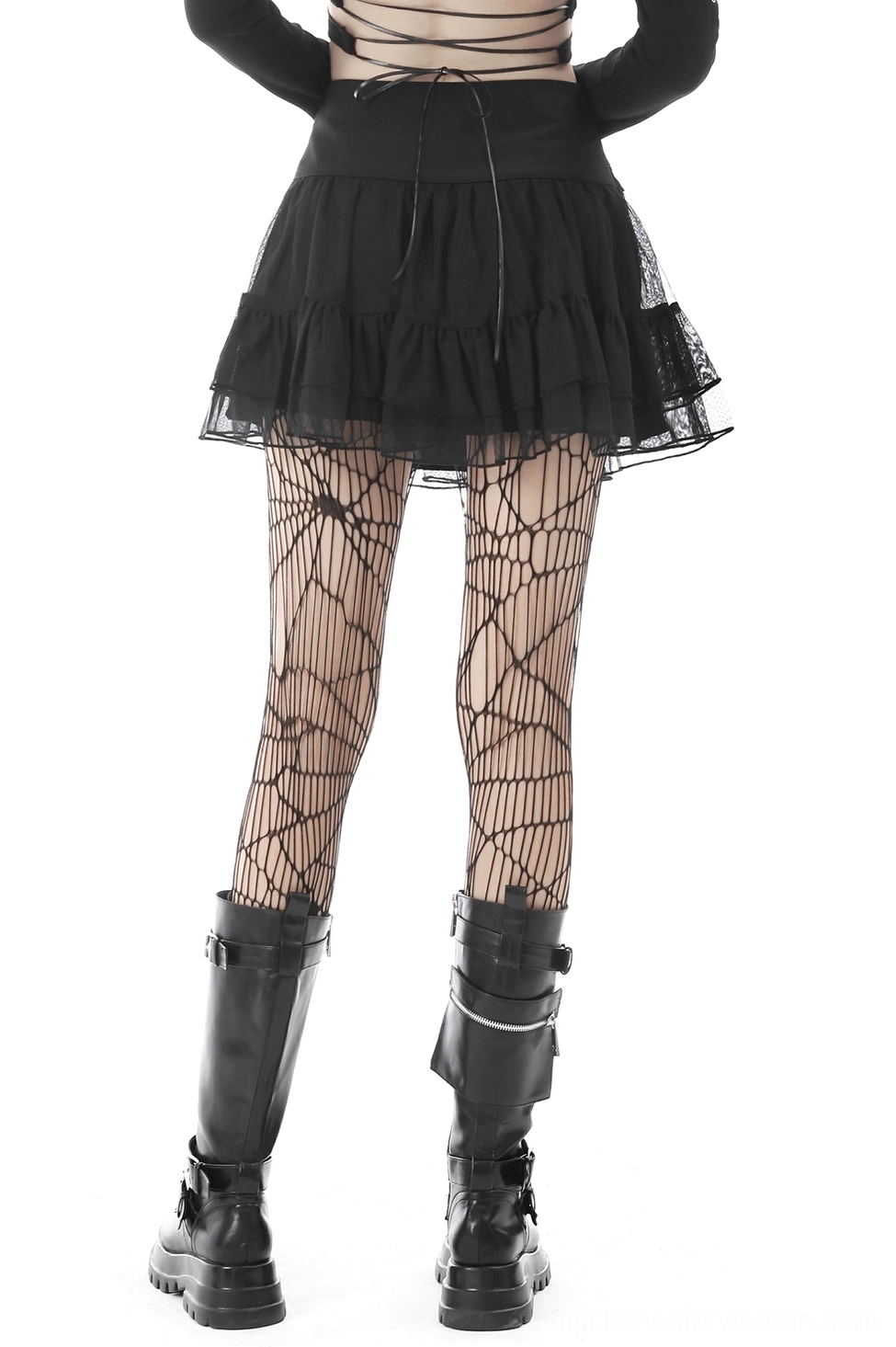 Gothic black mini skirt with tiered mesh design and skull chain, worn with fishnet tights and combat boots, rear view