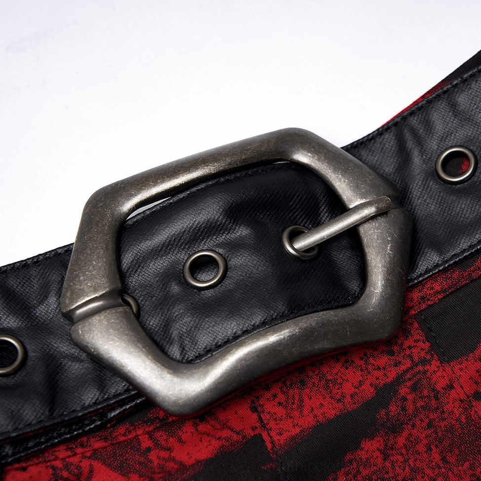 Close-up of vintage metal buckle and black leather waistband on gothic A-line skirt with eyelet details