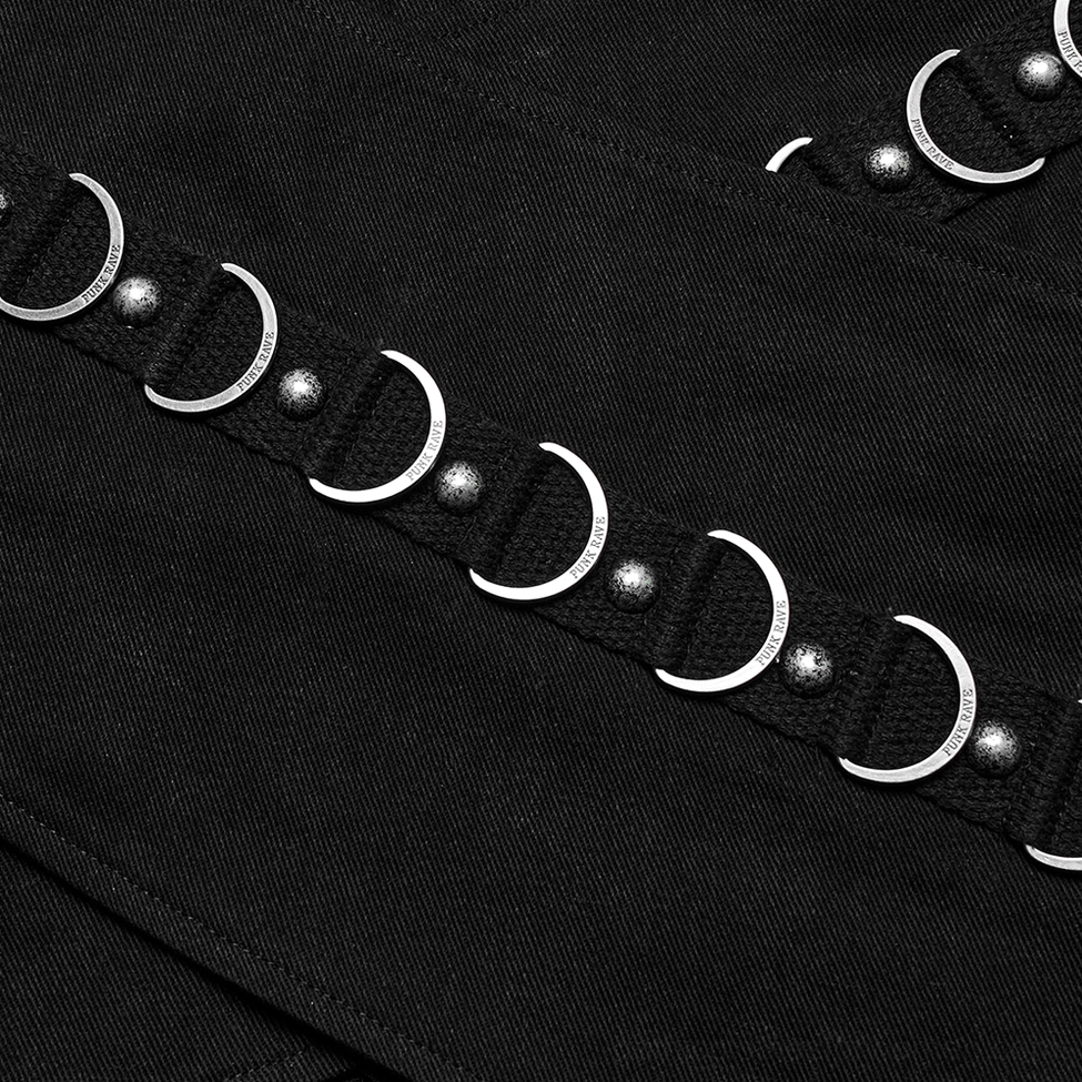 Close-up of matte silver crescent ring metal trim and riveted black strap detail on gothic skirt