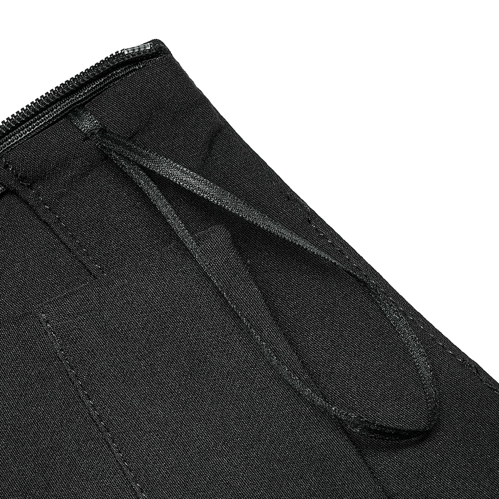 Close-up detail of metal zipper waistband closure and fabric belt loops on gothic plaid mini skirt