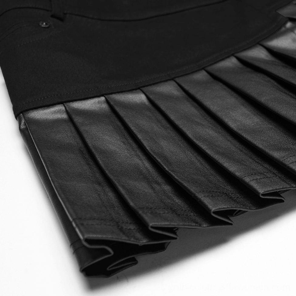 Close-up macro shot of sharp structured pleats on black faux leather panel of gothic skirt showing matte black finish and clean stitched pleat edges