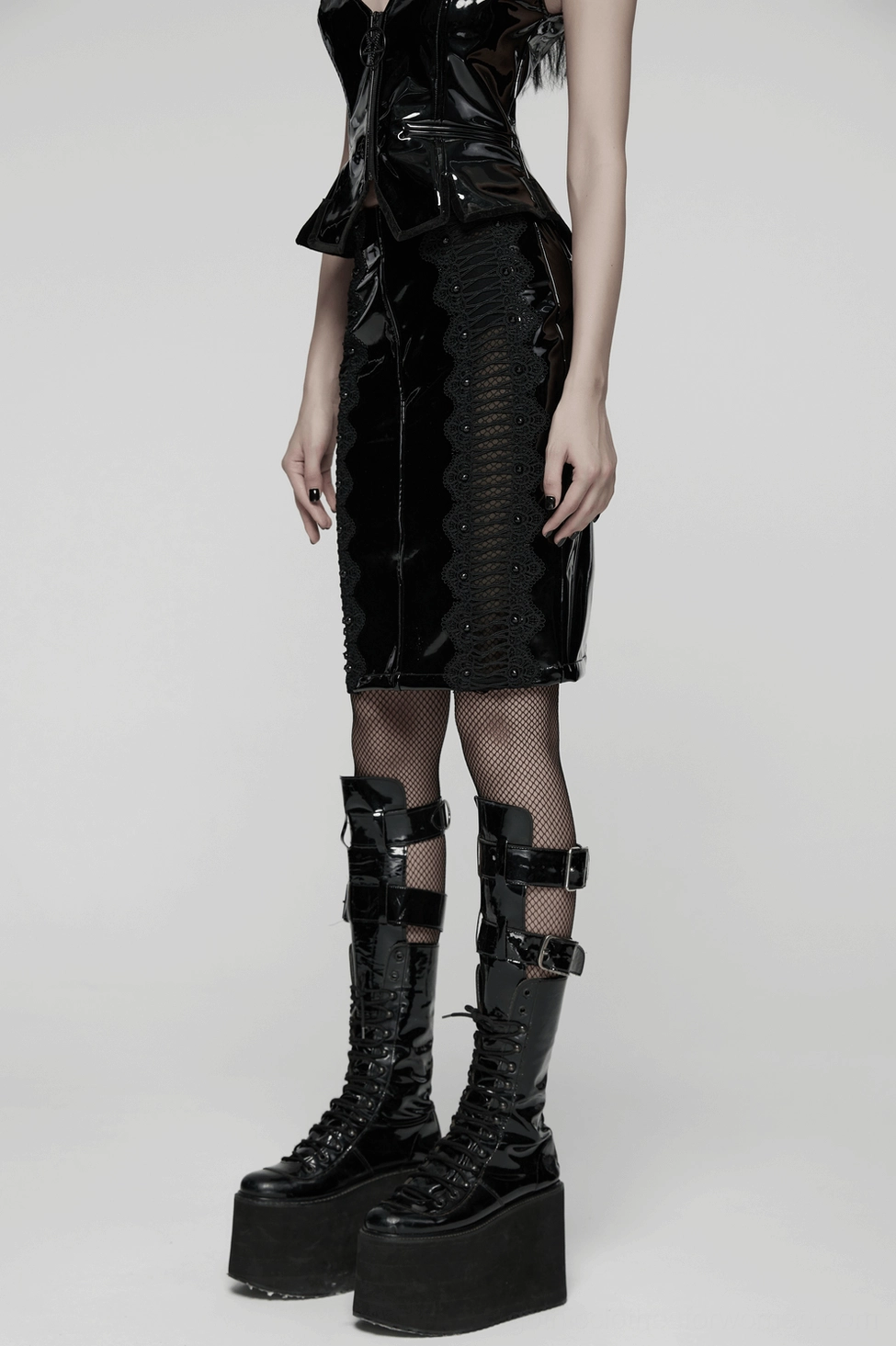 Black gothic patent leather skirt rivet embellishment and mesh panel construction detail