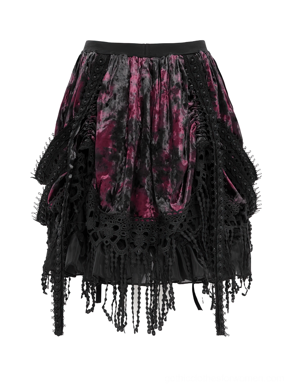 Low angle flat lay of gothic layered skirt displaying ruched velvet fabric and tassel hem trim