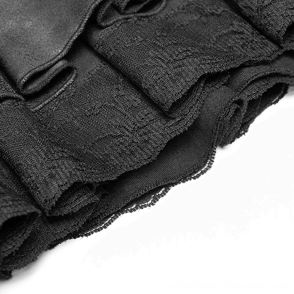Close-up detail of black gothic skirt hem showing frayed ruffle edge and textured woven fabric layers