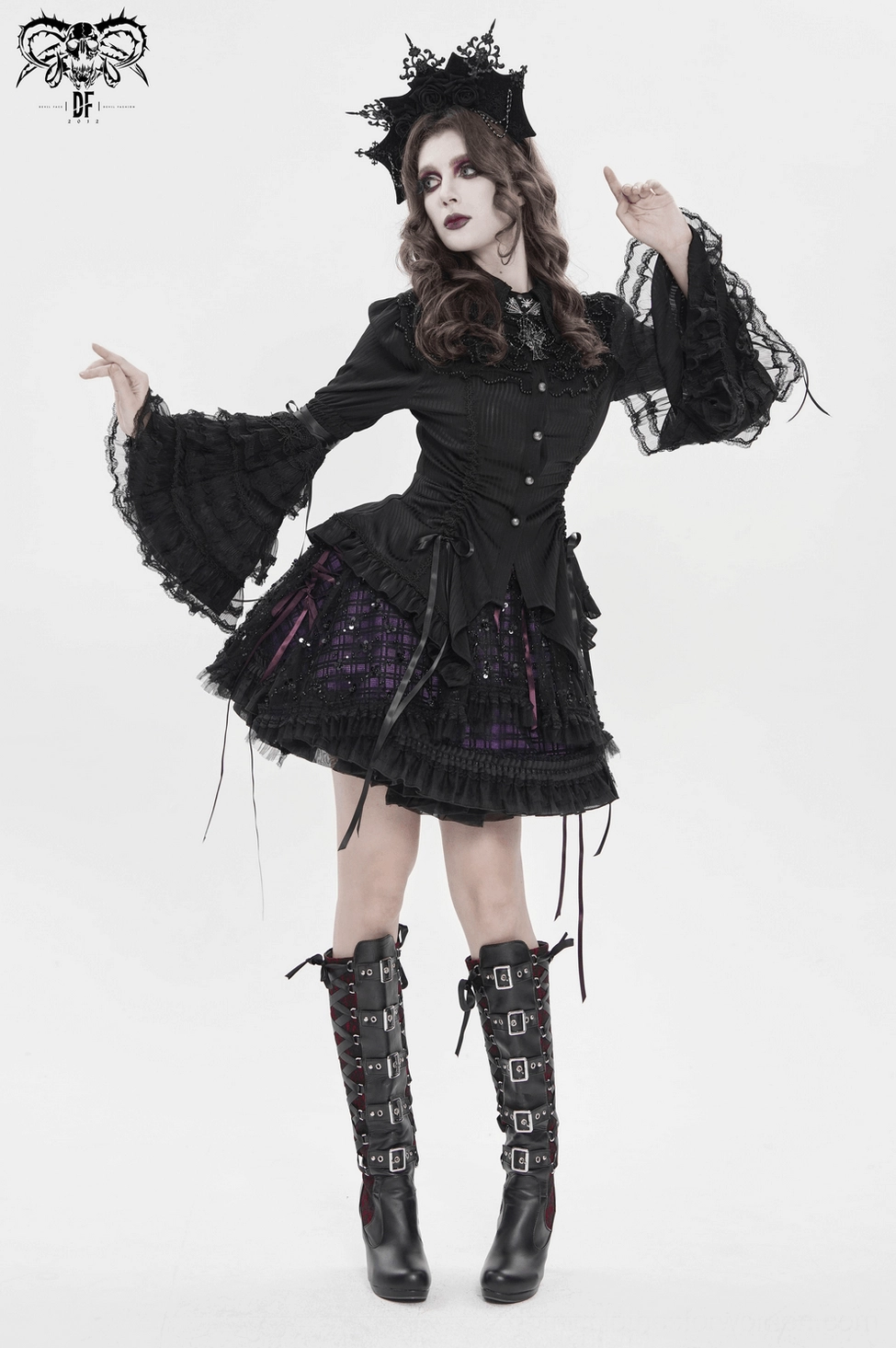 Gothic purple tulle skirt detail photograph highlighting satin ribbon elements, lace-up construction, and ruffled trim for dark romantic aesthetic