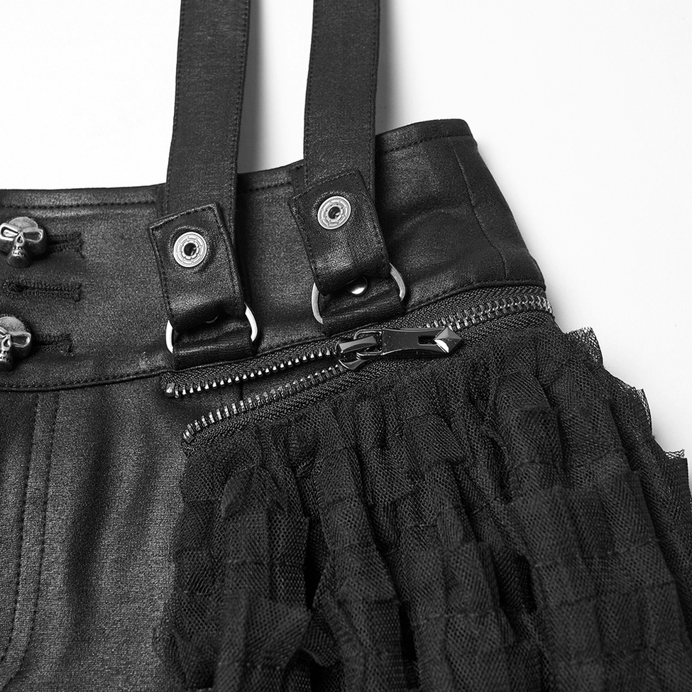 Close-up detail of gothic skirt-shorts waist showing snap straps, zipper accent, skull metal charms and black tulle fabric
