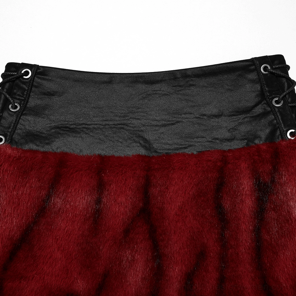 Close-up side view of flame tie-dye gothic skirt showing eyelet holes and black faux leather side strap hardware