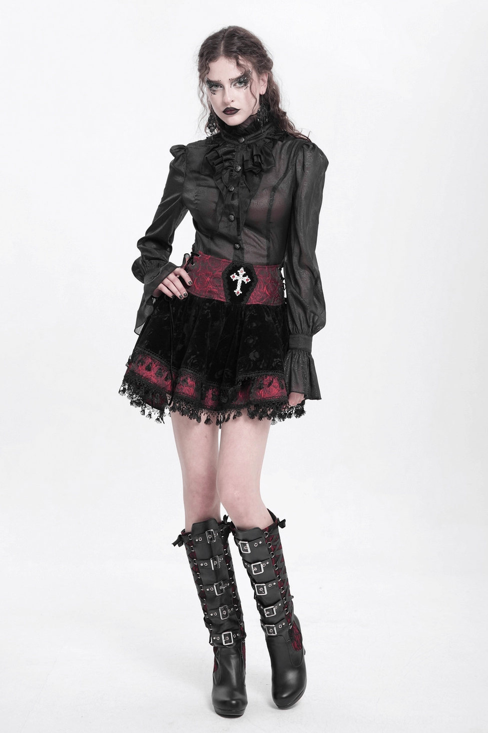 Close-up of gothic skirt waistband showing silver cross embroidery and red rose jacquard fabric detail