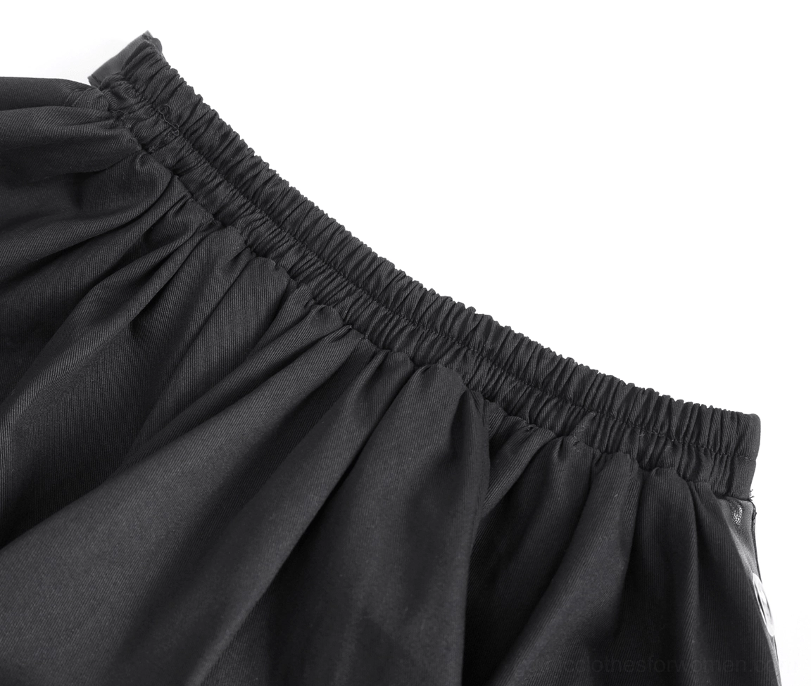 Macro close-up of elasticated black waistband with shirred elastic detail and woven fabric texture of gothic ruffle skirt