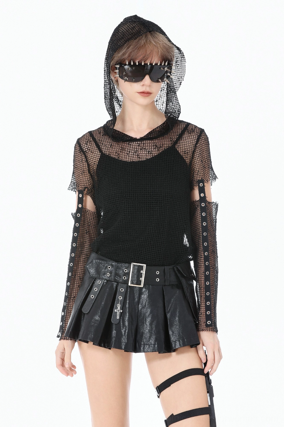 Styled photo of gothic pleated leather skort paired with black boots and alternative fashion accessories