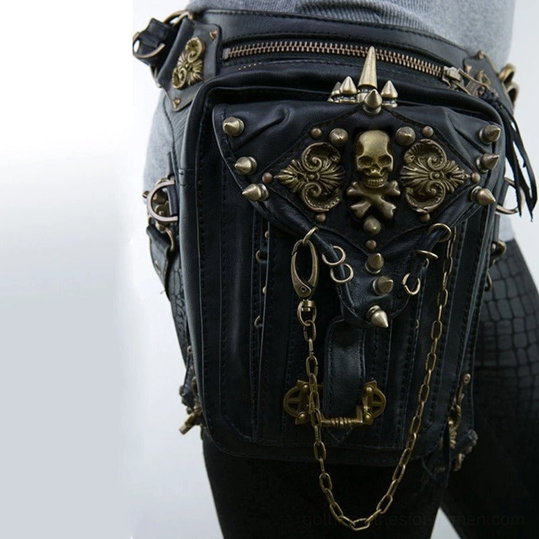 Close-up product shot of gothic steampunk waist bag showing bronze skull decoration, zippered pockets, and metal chain accents