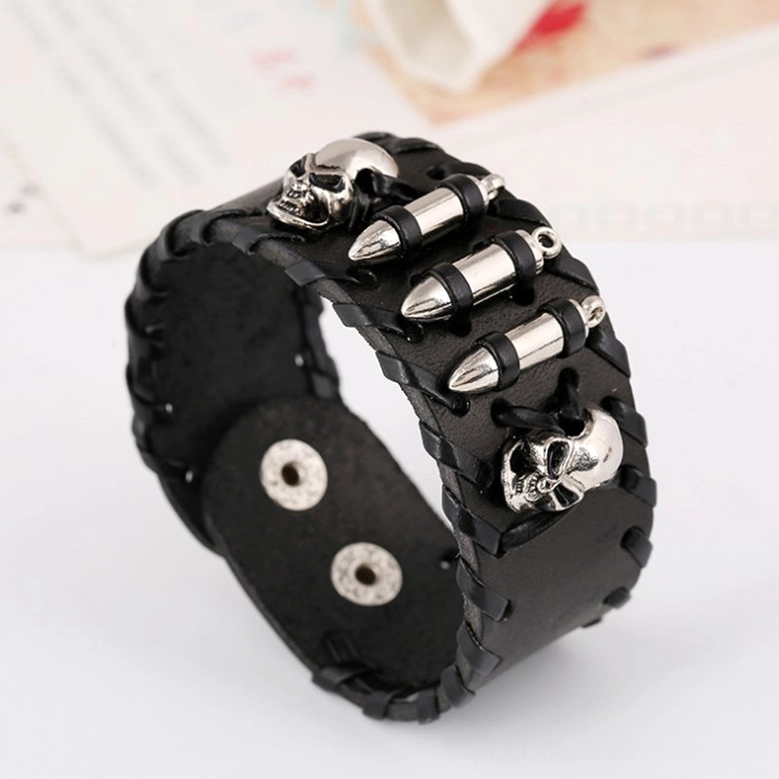 Black woven leather gothic skull bracelet with silver metal skull and bullet charms, three-quarter side view displaying toggle clasp and detailed craftsmanship