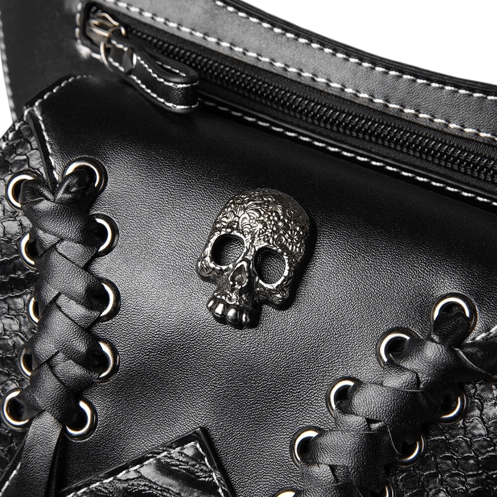 Metal skull emblem close-up with lace-up grommets and antique hardware detail