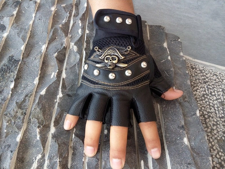 Gothic skull rivet half-finger gloves detail shot showing metal studs and leather texture