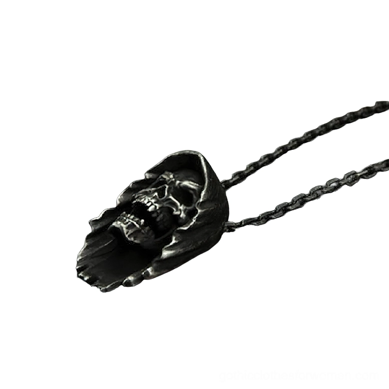 Low side angle view of hooded skull pendant displaying open-mouthed expression on dual stainless steel curb chains