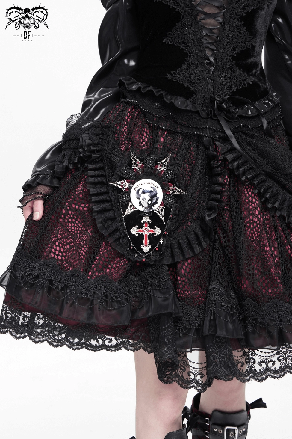 Gothic skull pin badge attached to black gothic punk skirt with lace hem and dark fashion styling