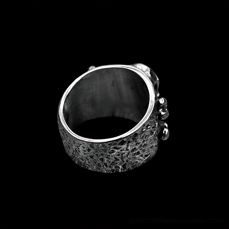 Bottom inner view of gothic skull crossbones ring showing textured band and fine engraved details on rim
