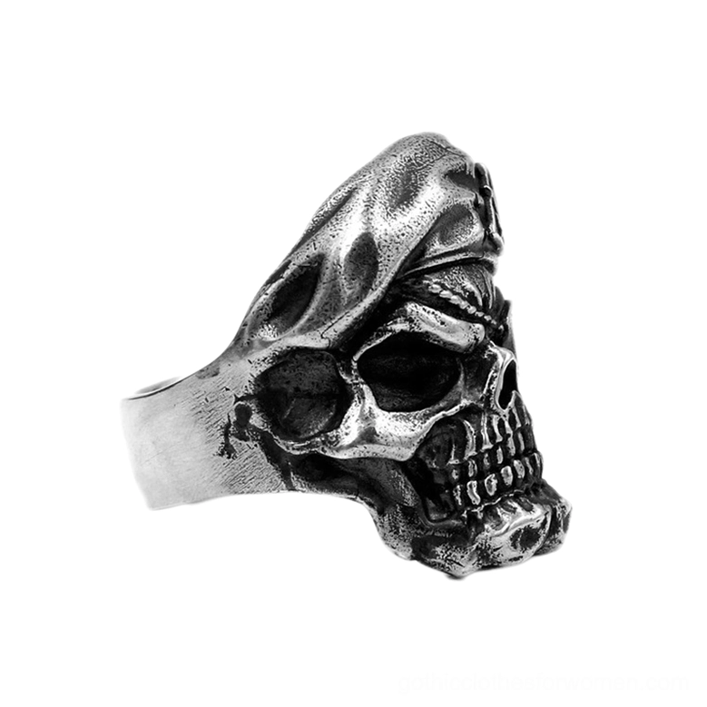 Left side three-quarter view of antique silver skull ring showing ring band and complete design silhouette