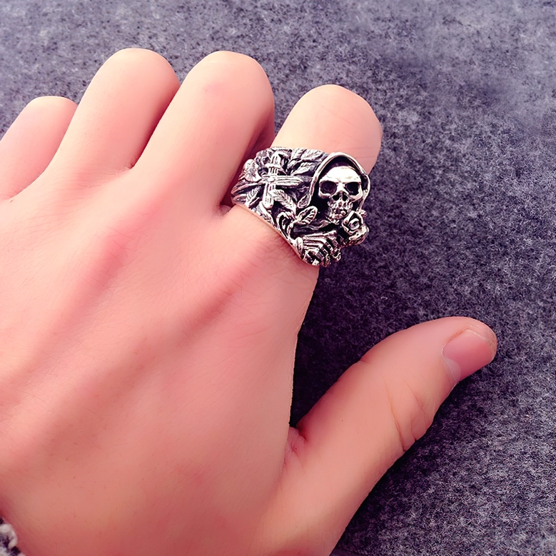Grim reaper skull ring worn on finger displaying vintage silver finish and dimensional carved details in actual wear
