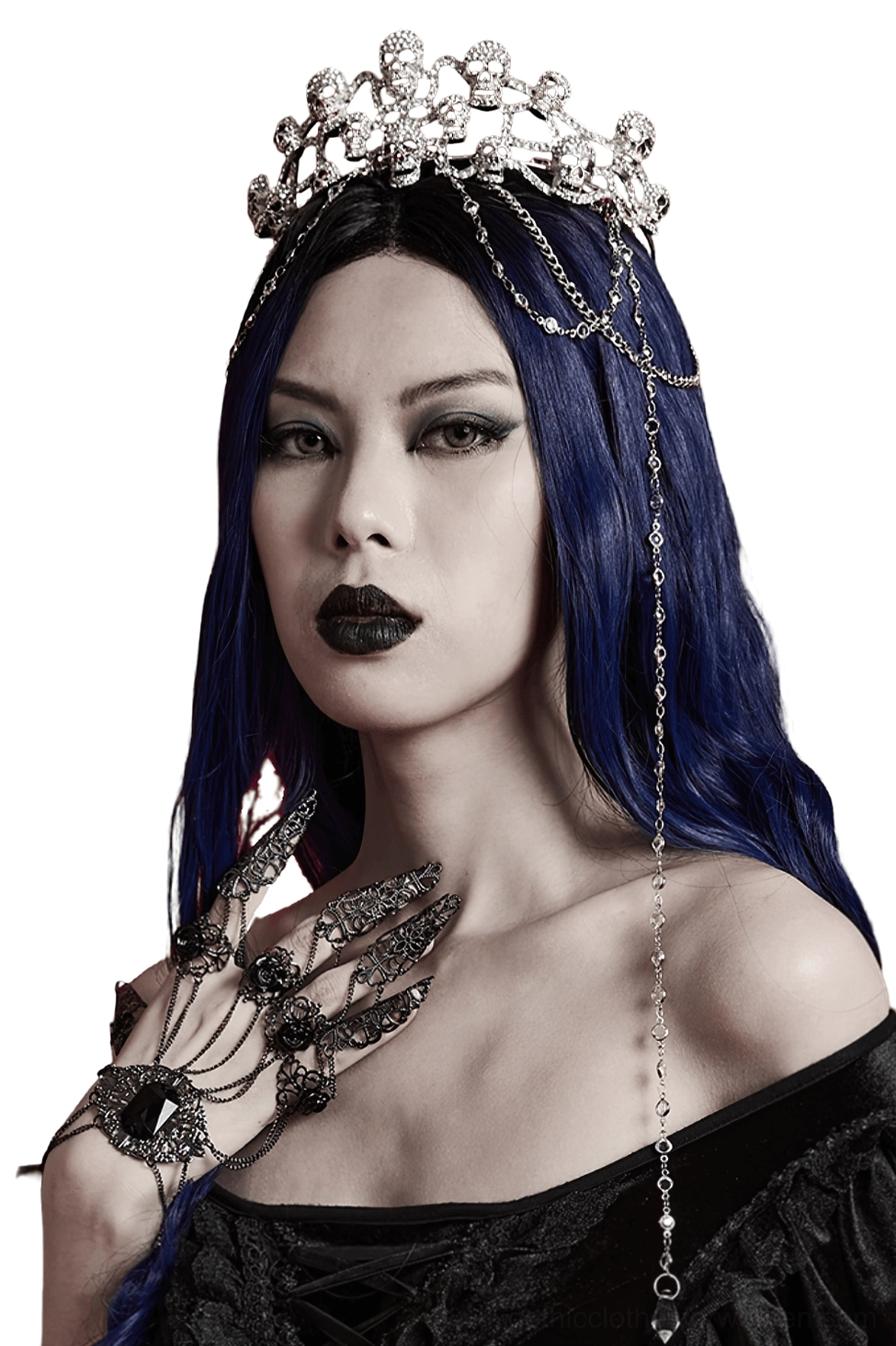 Gothic skull tiara with cascading crystal chains worn by dark-haired model in front view against white studio backdrop