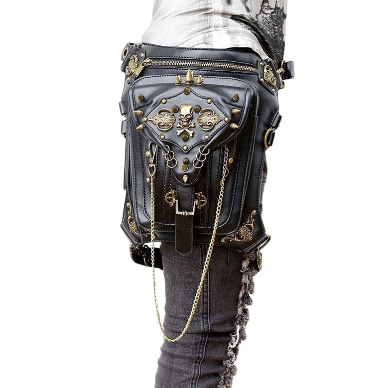 Black gothic waist bag with bronze skull rivets worn as leg holster on female model, rear view showing adjustable strap and hanging chains