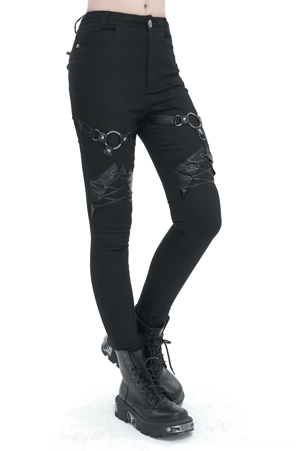 Black gothic slim-fit pants with thigh O-rings and lace-up knee details, worn by female model with platform boots, front oblique view