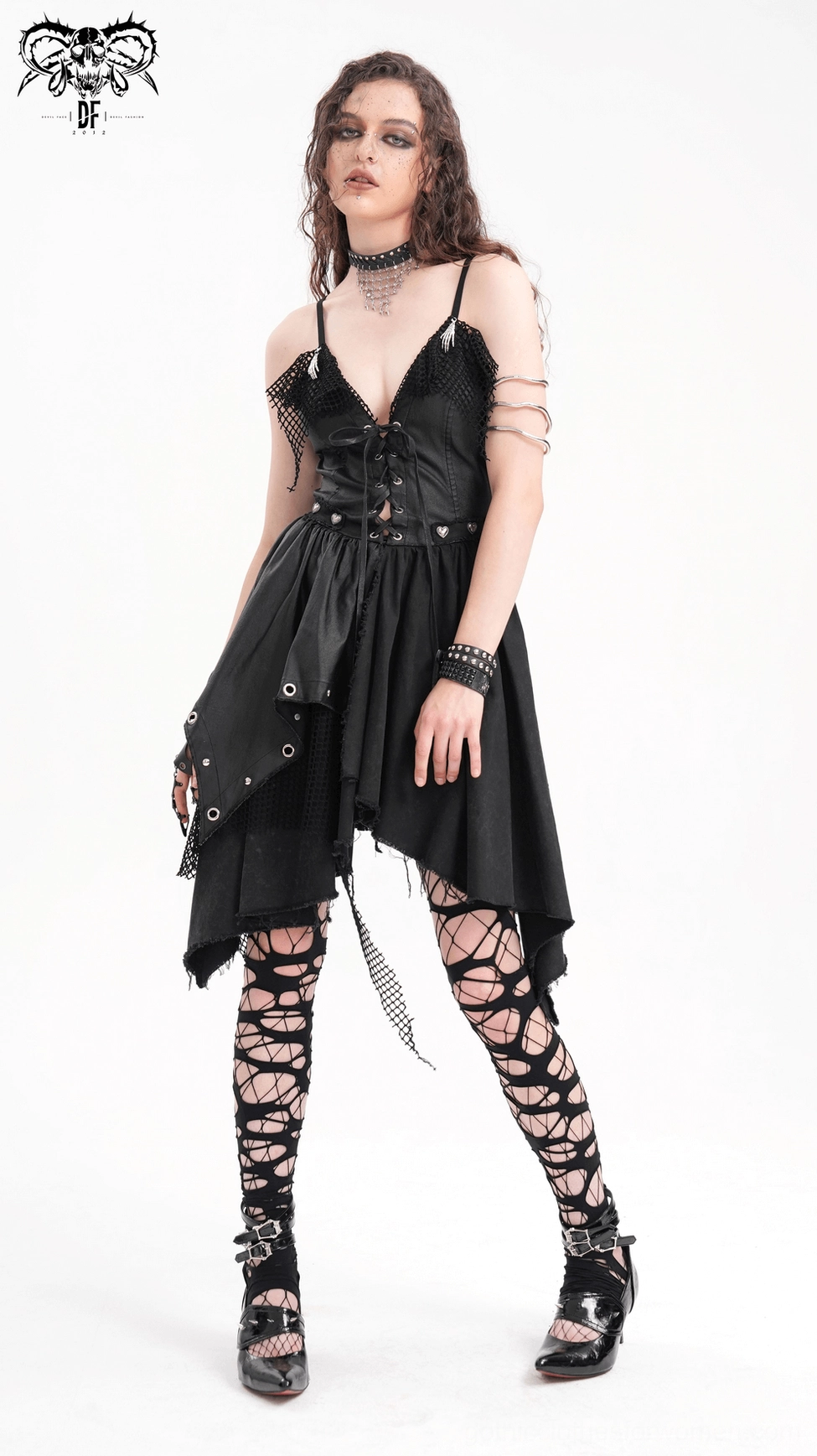 Three-quarter view of gothic slip dress emphasizing lace-up front and dramatic asymmetric hem styling