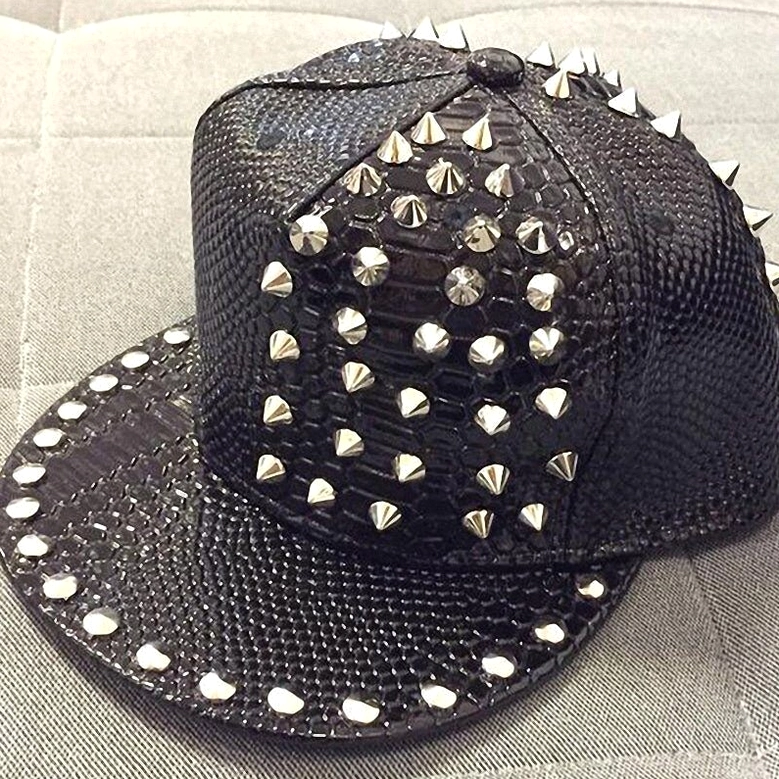 Three-quarter front view of black snakeskin gothic baseball cap with silver rivets and spike decorations, alternative fashion headwear