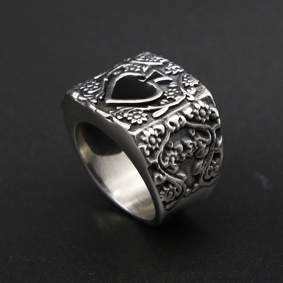 Spade gothic men's ring side angle on dark background showing polished inner band and intricate floral carvings