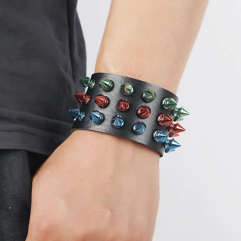Wearing view of multicolor spike gothic cuff bracelet on wrist with casual clothing, real-life styling demonstration