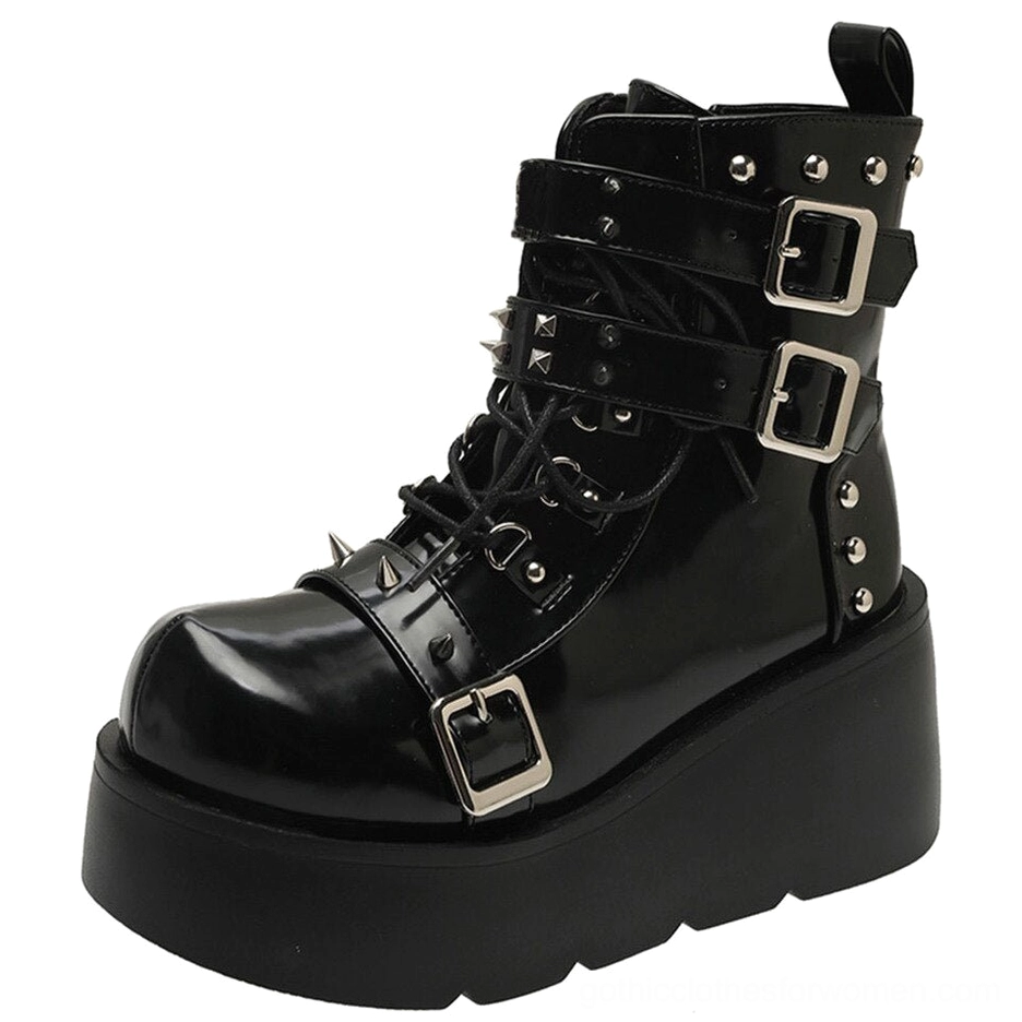 Gothic spiked platform ankle boot in black patent leather with buckles and rivets side view