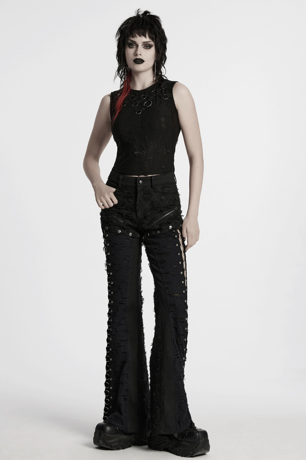 Black gothic pants with metal O-ring slits styling detail - distressed fabric close-up