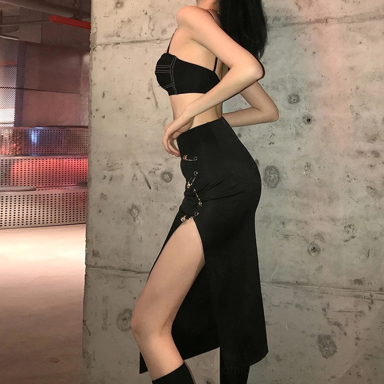 Black split midi skirt side profile on model emphasizing slim silhouette and high side slit details