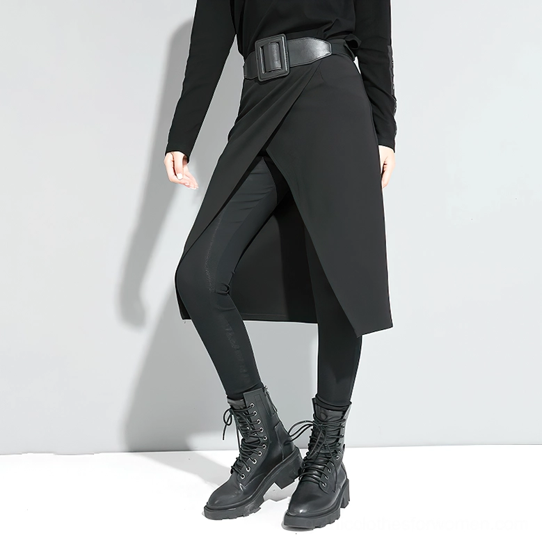 Women's black gothic split pants with asymmetric side split design - side three-quarter view showing leather belt and hem