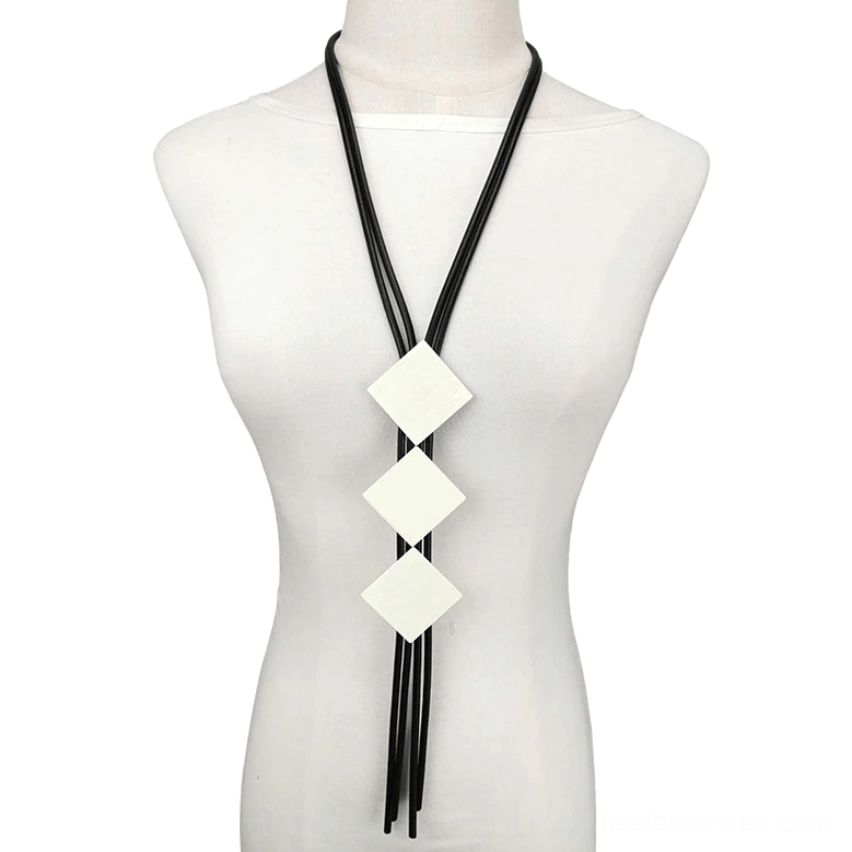 Square wood pendant gothic necklace displayed on white mannequin bust, featuring three beige square wooden charms with black elastic rubber tassel cord, frontal view