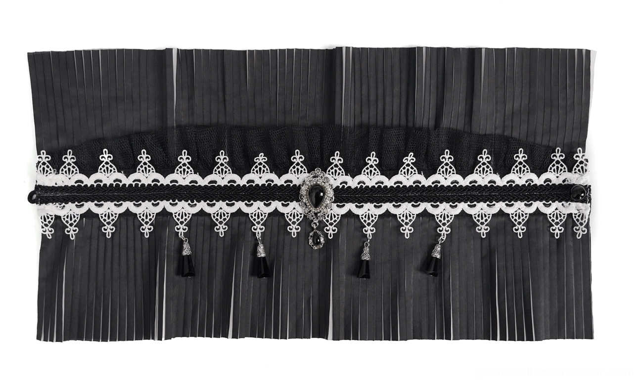 Unfolded flat lay of gothic pleated collar showing central gem pendant and complete lace and tassel trim design